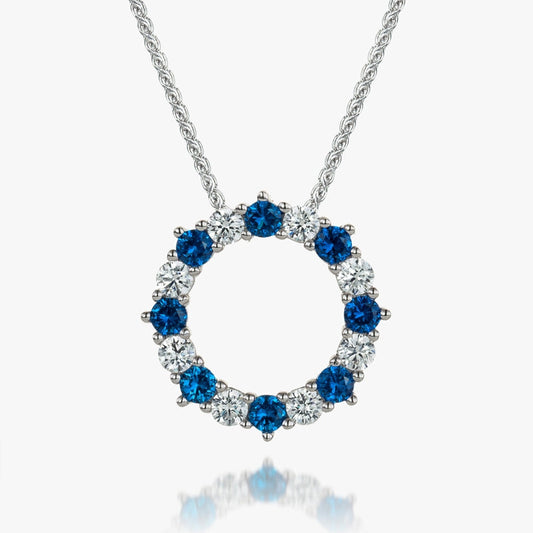 circle outline claw set pendant set with alternating blue and white stones